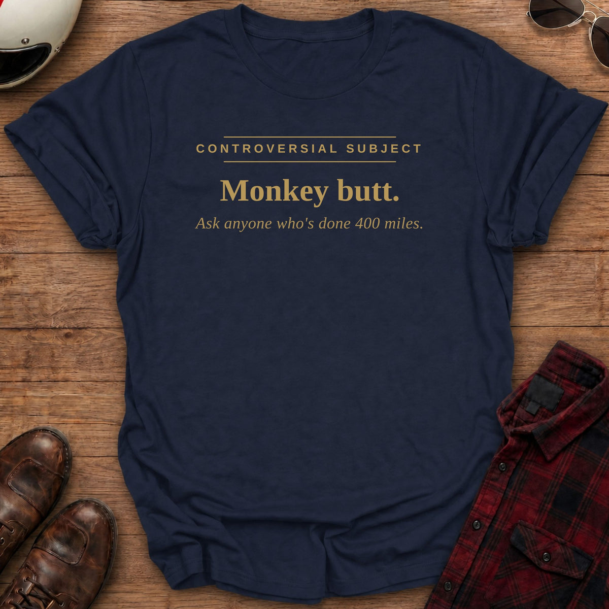 Navy t-shirt with gold type reading Controversial Subject. Monkey butt. Ask anyone who's done 400 miles.