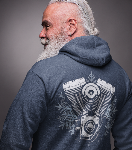 A man with a gray beard and hair tied back wears a navy blue hoodie from the back, showing a large white graphic of a V-twin motorcycle engine with snowflake details.