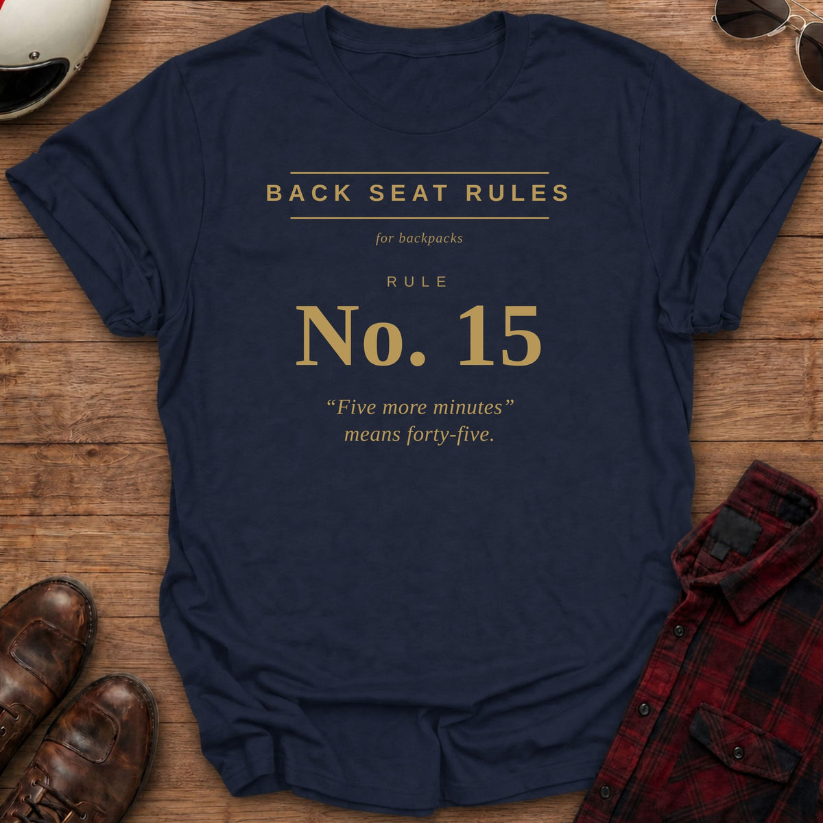 Navy t-shirt with gold type on the front reading Back Seat Rules, for backpacks, Rule No. 15: "Five more minutes" means forty-five.