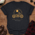 Black t-shirt with gold line art of a cruiser motorcycle under a large sun inside a double ring with stars, text reads AWAKE(NING), Work in progress
