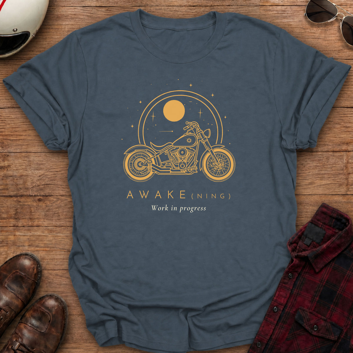 Dark heather grey t-shirt with gold line art of a cruiser motorcycle under a large sun inside a double ring with stars, text reads AWAKE(NING), Work in progress