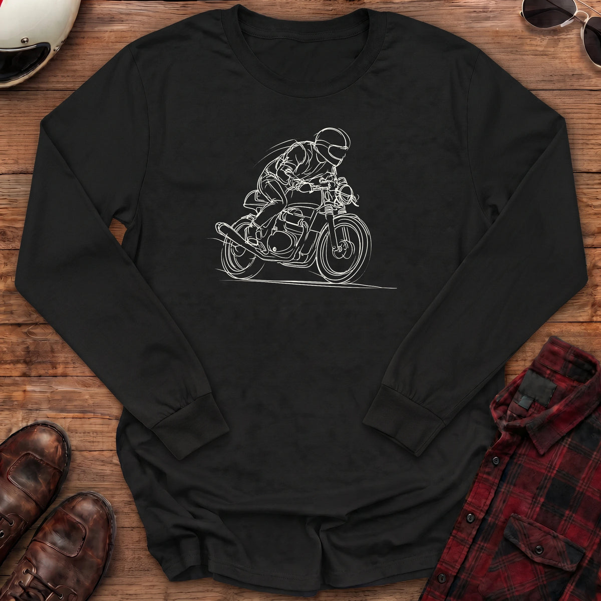 Black long-sleeve shirt with a loose white line-art sketch of a helmeted rider tucked low on a cafe racer motorcycle leaning into a corner, with wind lines and a ground line