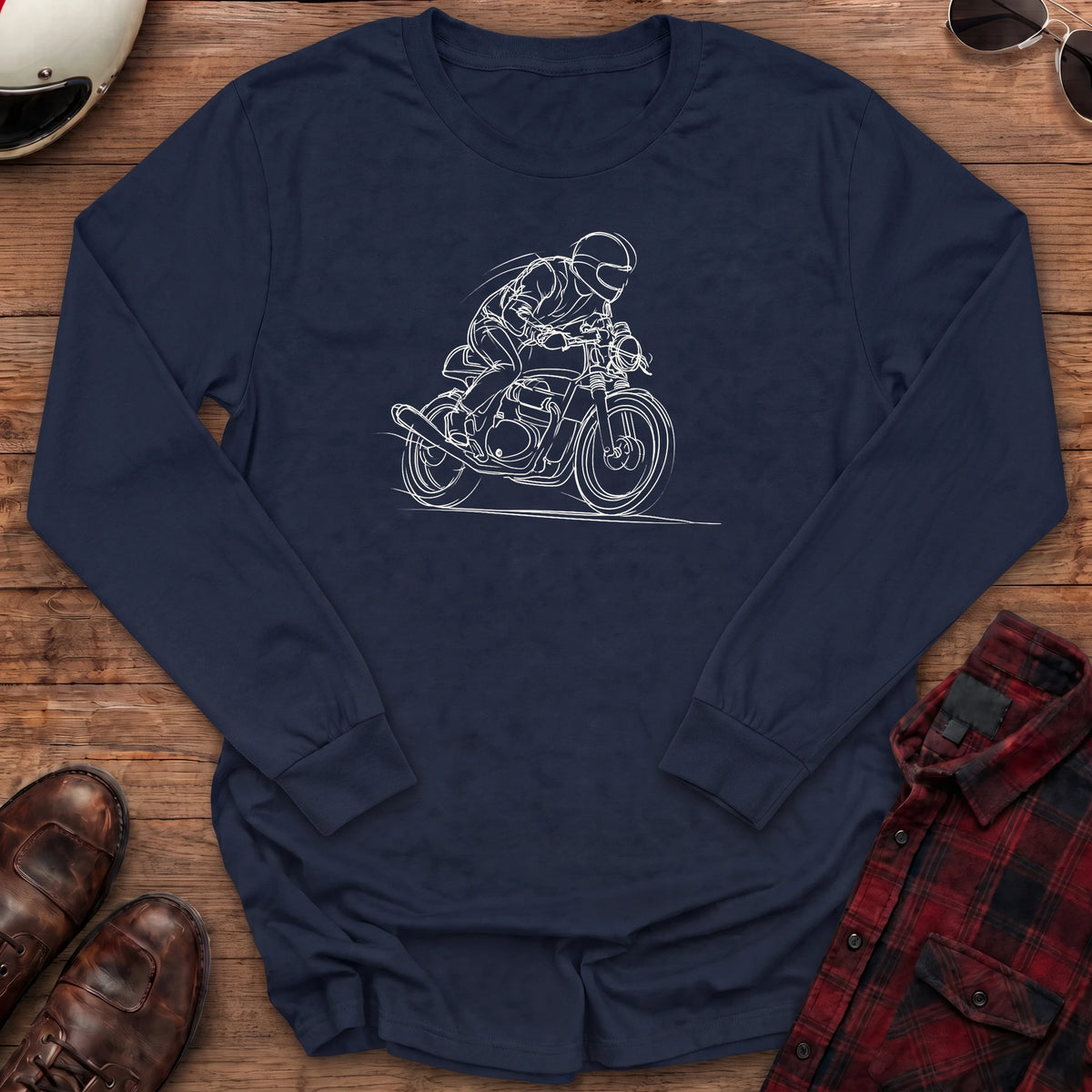 Navy long-sleeve shirt with a loose white line-art sketch of a helmeted rider tucked low on a cafe racer motorcycle leaning into a corner, with wind lines and a ground line